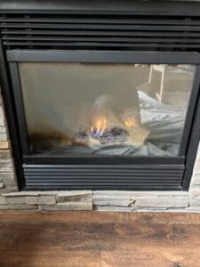 Dirty glass on a gas fireplace before a cleaning